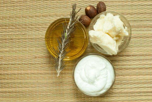 Natural skincare ingredients including shea butter, essential oil, and a creamy lotion
